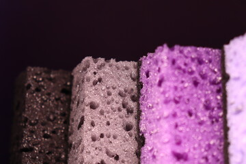 stylish dark sponges for washing dishes and cleaning on a purple background