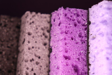 stylish dark sponges for washing dishes and cleaning on a purple background