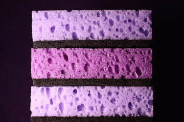 stylish dark sponges for washing dishes and cleaning on a purple background