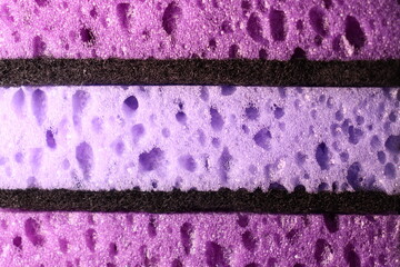 stylish dark sponges for washing dishes and cleaning on a purple background