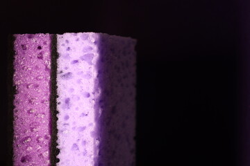 stylish dark sponges for washing dishes and cleaning on a purple background
