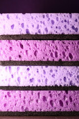 stylish dark sponges for washing dishes and cleaning on a purple background