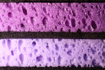 stylish dark sponges for washing dishes and cleaning on a purple background