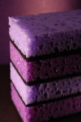 stylish dark sponges for washing dishes and cleaning on a purple background
