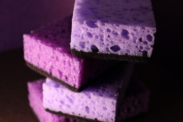 stylish dark sponges for washing dishes and cleaning on a purple background