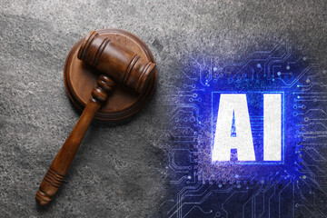 Artificial intelligence and law. Judge's gavel and AI abbreviation on grey table