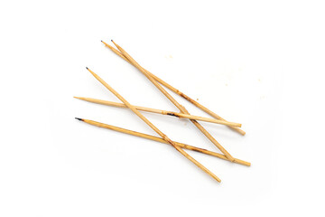 Leftover skewers of grilled pork sticks isolated on white background.
