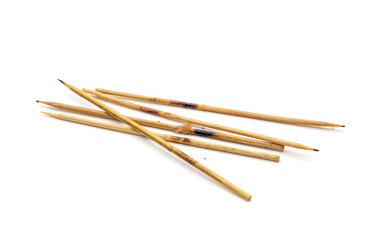 Leftover skewers of grilled pork sticks isolated on white background.