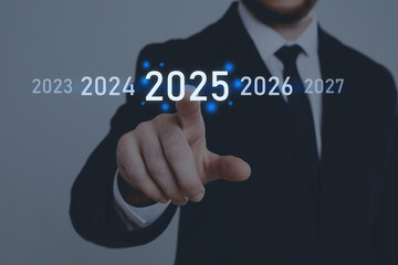 New year goals. Businessman touching 2025 on virtual screen against grey background, closeup