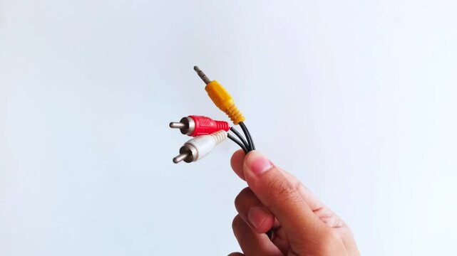 Man Holding RCA Stereo Audio Cable Isolated on White Background.
