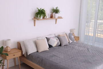 Large bed near window in room. Stylish bedroom interior