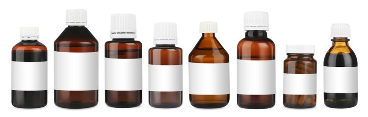 Many different glass bottles with labels isolated on white