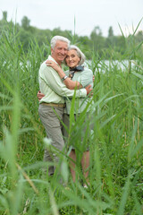 Beautiful senior couple relaxing and posing in the summer park