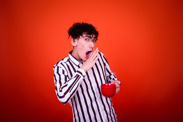 Funny young attractive student with curly hair posing in studio. Study and exams.