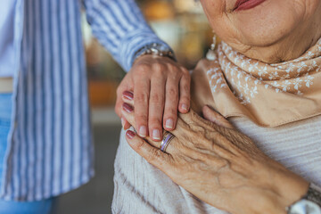 Young Hand Comforting Elderly Woman in Warm Moment