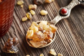 Frankincense resin crystals on a metal spoon