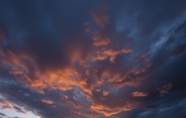 Clouds of deep indigo and amber, with a faint, golden light breaking through the edges.