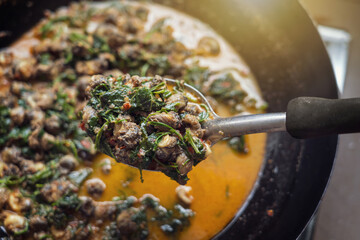 Thai Curry with River Snail. Fresh snail meat in spicy thick soup fresh coconut milk add cha-om and...