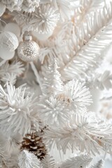 A close-up shot of a white Christmas tree with ornaments and lights
