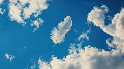 Floating White Feather in a Bright Blue Sky