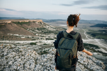 adventure awaits woman with backpack gazing over valley from mountain summit