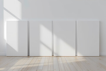Fototapeta premium Four blank canvases stand against a minimalist white wall, illuminated by soft light, creating a serene and artistic atmosphere.