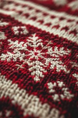 A close-up view of a red and white knitted blanket with intricate patterns