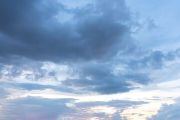 Dramatic cloudscape paints the sky with fluffy white clouds against a deep blue canvas