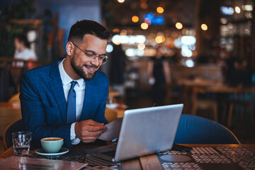 Confident Businessman Enjoying Coffee While Working in a Cafe