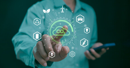 Businessman point to increasing arrow with carbon reduction for decrease CO2, Green house Global Economy concept. Carbon footprint and carbon credit to limit global warming from climate change.