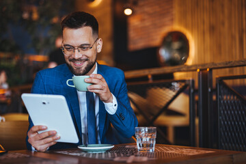 Businessman in Cafe Enjoying Coffee and Tablet Browsing