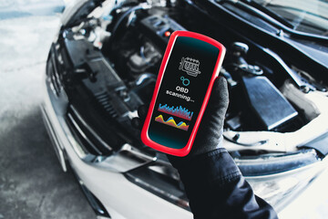 OBD scanner tools , OBD Scanner in use by mechanic over car engine background for analysis engine...