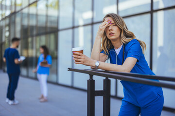 Tired Nurse Taking a Break Outside Hospital Building