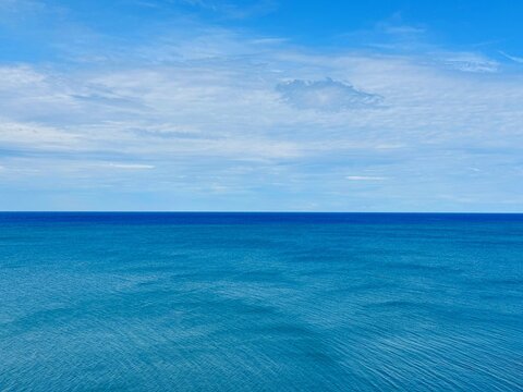 Blue calm sea and cloudy sky. 