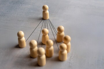 A single figure stands out from a group of others, with lines connecting it to the surrounding...