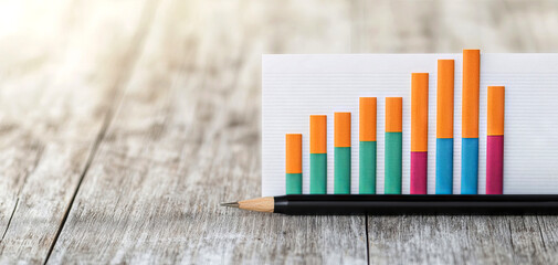 A colorful bar graph displayed on a wooden surface, illustrating statistical data in a visually appealing manner.