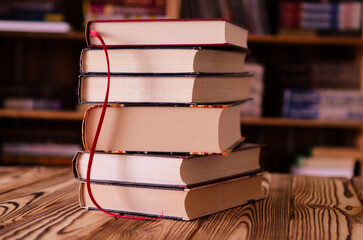 Old books against the background of bookshelves. Books