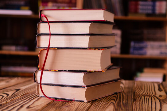 Old books against the background of bookshelves. Books
