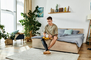 A stylish young man sits on his bed, sipping coffee while appreciating his serene surroundings.