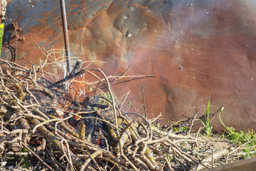 
a pile of branches for a fire place on a metal tin background