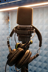 Microphone and headphones in recording studio