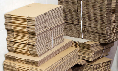 Stacking used cardboard box for recycling.