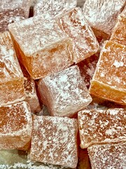 Turkish delight or simply lokum is a confectionery product in the form of soft, translucent sugar-starch cubes sprinkled with powdered sugar.