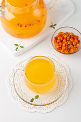Sea buckthorn tea drink with oranges and mint. Autumn comfort hot drink. Herbal vitamin tea. 