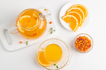 Sea buckthorn tea drink with oranges and mint. Autumn comfort hot drink. Herbal vitamin tea. 
