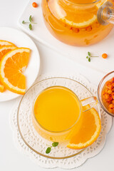 Sea buckthorn tea drink with oranges and mint. Autumn comfort hot drink. Herbal vitamin tea. 