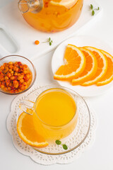 Sea buckthorn tea drink with oranges and mint. Autumn comfort hot drink. Herbal vitamin tea. 