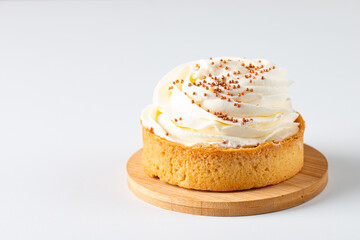 Lemon tartlets with whipped cream, sprinkles and chocolate chips on white background