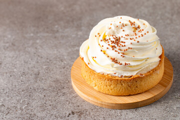 Lemon tartlets with whipped cream, sprinkles and chocolate chips on white background