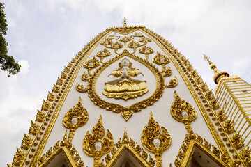 Wat Phra That Nong Bua, Ubon Ratchathani, inside there is the Phra That Sri Maha Bodhi Chedi, a replica of the Chedi in Bodh Gaya, India, stucco sculptures, candles, and two large Naga statues.